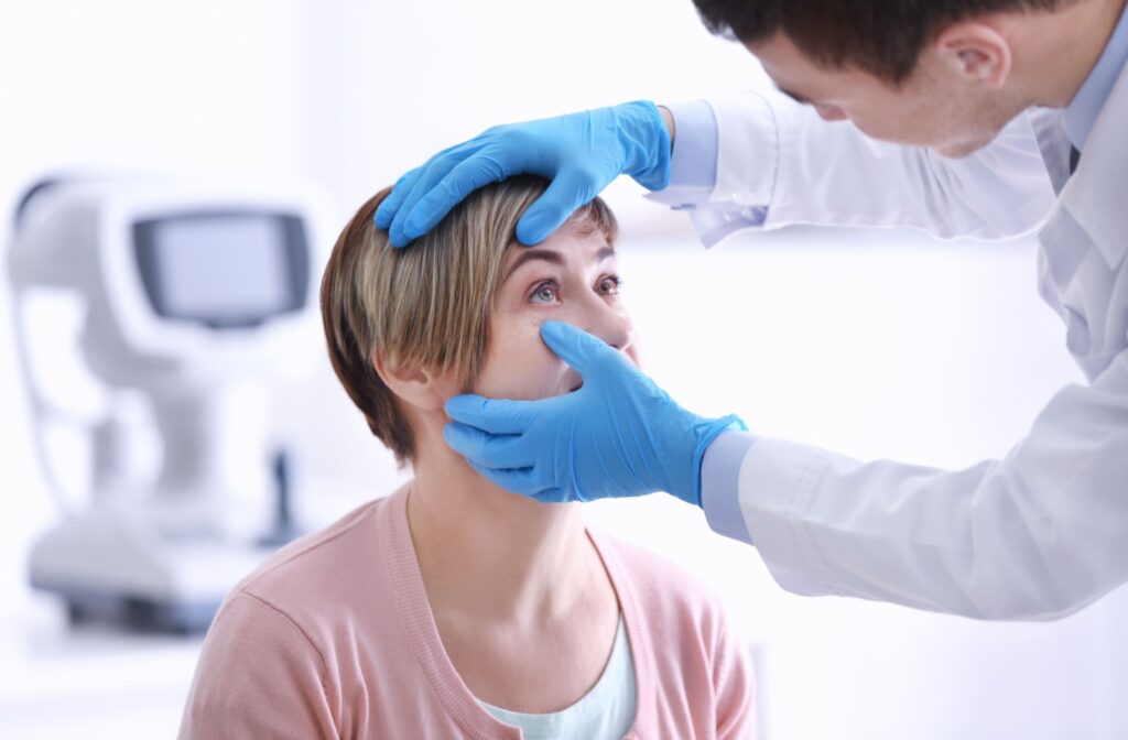 An eye doctor checking a female patient's eye for infections.