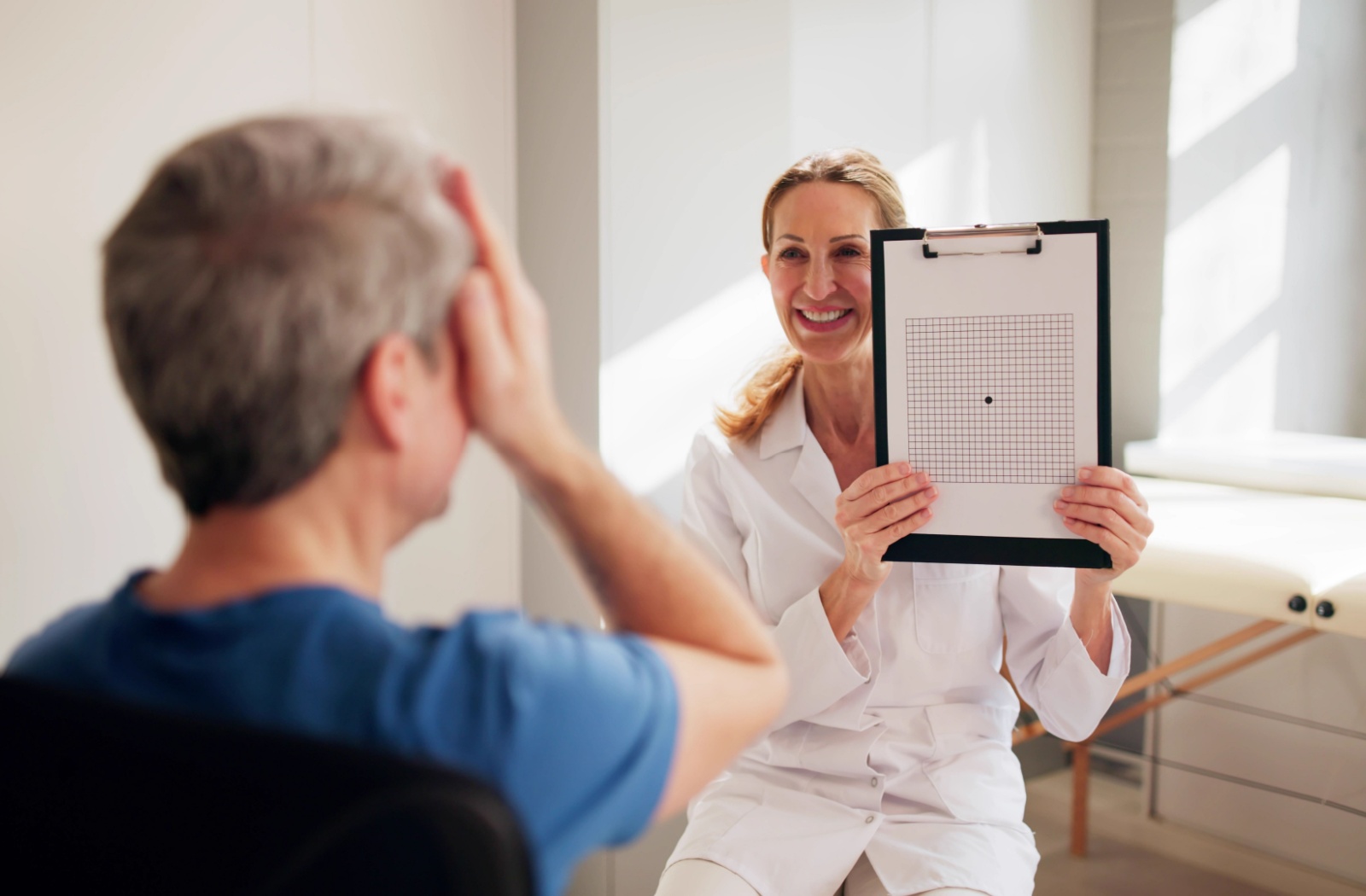 An eye doctor assesses a patient's macular health with an Amsler Grid.