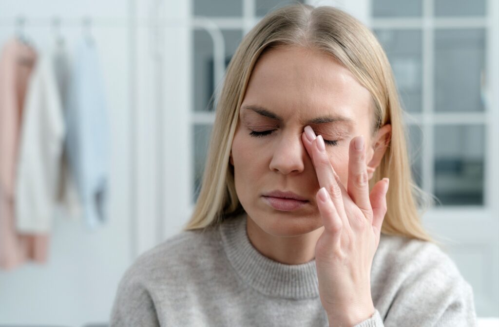 Person rubbing their eye due to dry eye discomfort.